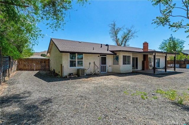 16117 Sweetaire Ave, Lancaster, CA 93535 - back of property featuring central air condition unit, stucco siding, a fenced backyard, a chimney, and a patio area