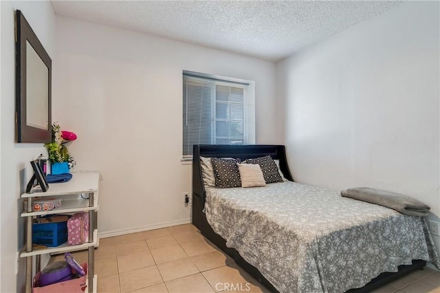 16117 Sweetaire Ave, Lancaster, CA 93535 - bedroom with light tile patterned floors, a textured ceiling, and baseboards