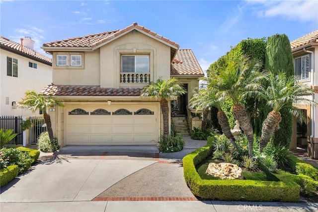 5 Monaco, Dana Point, CA 92629 - view of front of house with a tile roof, an attached garage, driveway, and stucco siding