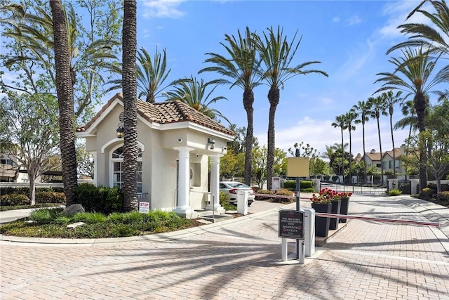 5 Monaco, Dana Point, CA 92629 - view of side of home featuring stucco siding, a tile roof, and a gate