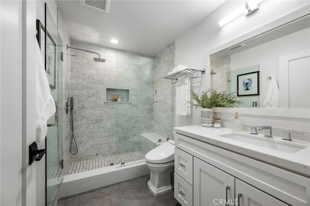 bathroom featuring tile patterned floors, visible vents, toilet, vanity, and a stall shower