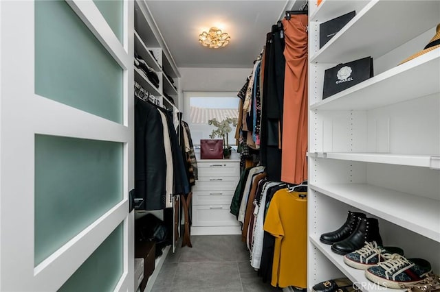 walk in closet with tile patterned flooring