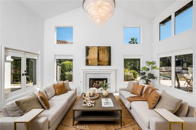 sunroom featuring an inviting chandelier, french doors, and plenty of natural light