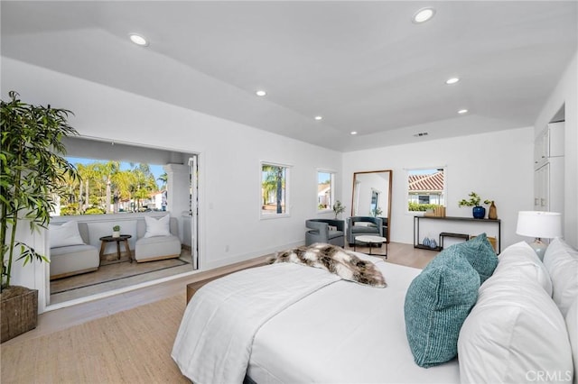 bedroom featuring recessed lighting, light wood-style flooring, and multiple windows