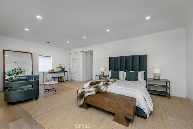bedroom with recessed lighting, light wood finished floors, visible vents, a closet, and baseboards