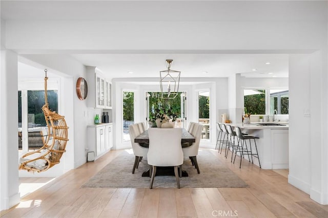 dining space featuring recessed lighting and light wood-style flooring