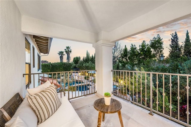 balcony at dusk with an outdoor hangout area