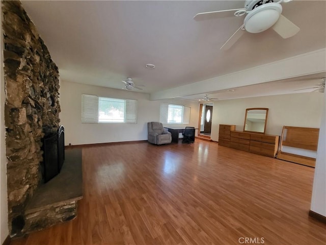 4322 Temescal Ave, Norco, CA 92860 - unfurnished living room featuring a ceiling fan, wood finished floors, and baseboards
