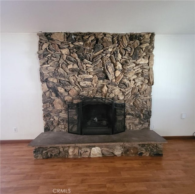 4322 Temescal Ave, Norco, CA 92860 - detailed view of wood finished floors, a stone fireplace, and baseboards