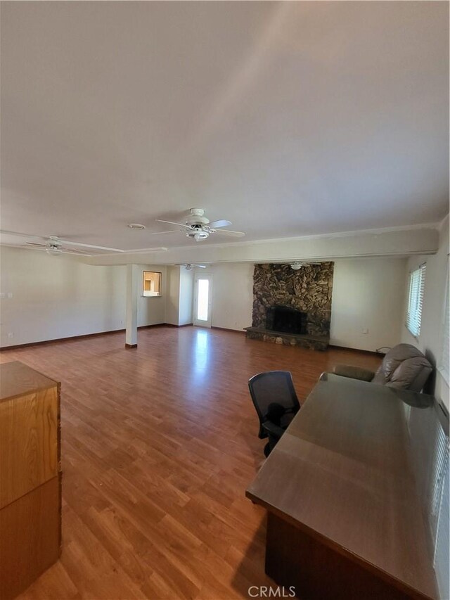 4322 Temescal Ave, Norco, CA 92860 - living area featuring a stone fireplace, a ceiling fan, light wood-type flooring, and ornamental molding