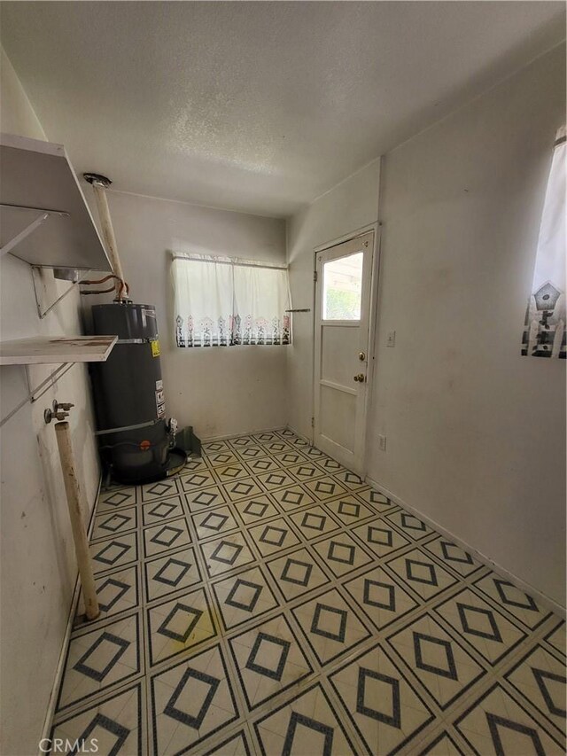 4322 Temescal Ave, Norco, CA 92860 - entryway featuring strapped water heater and a textured ceiling