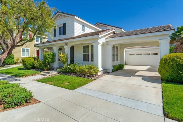 view of front of property featuring an attached garage, a front lawn, and concrete driveway