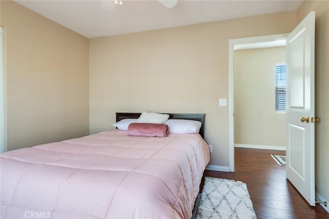 bedroom with baseboards, a ceiling fan, and wood finished floors