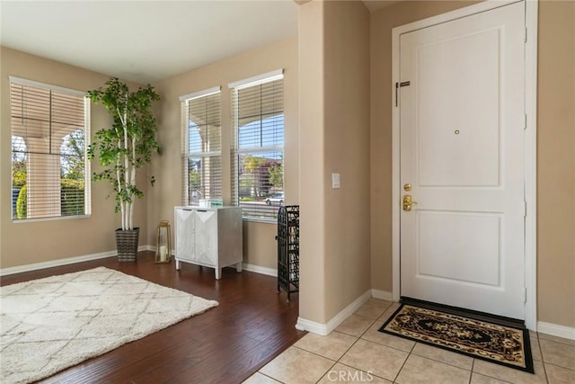foyer with wood finished floors and baseboards