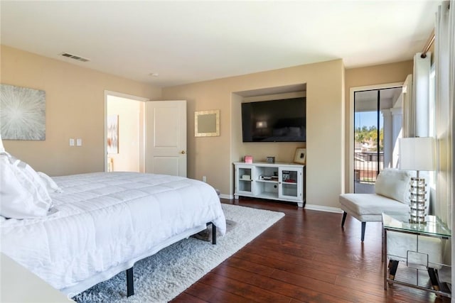 bedroom with baseboards, visible vents, dark wood-style floors, and access to exterior