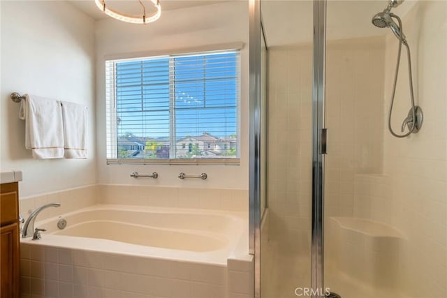 full bath with a bath, a shower stall, and vanity