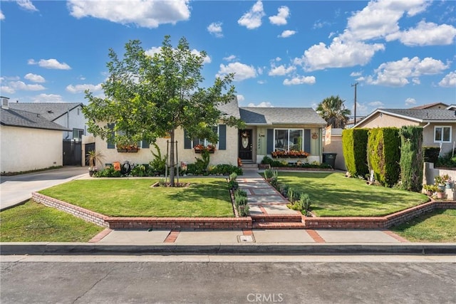 4045 N Walnuthaven Dr, Covina, CA 91722 - view of front of property featuring fence, a front lawn, and stucco siding