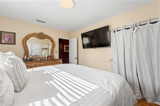 4045 N Walnuthaven Dr, Covina, CA 91722 - bedroom featuring wood finished floors and visible vents