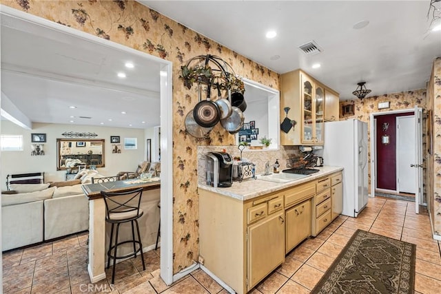 4045 N Walnuthaven Dr, Covina, CA 91722 - kitchen featuring wallpapered walls, visible vents, white refrigerator with ice dispenser, and a sink