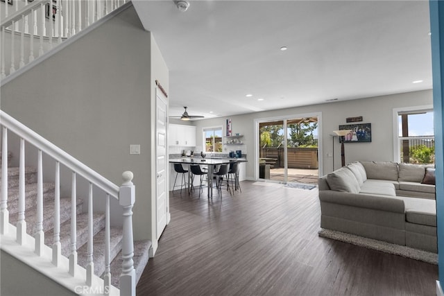living room featuring stairway, ceiling fan, recessed lighting, and dark wood-type flooring
