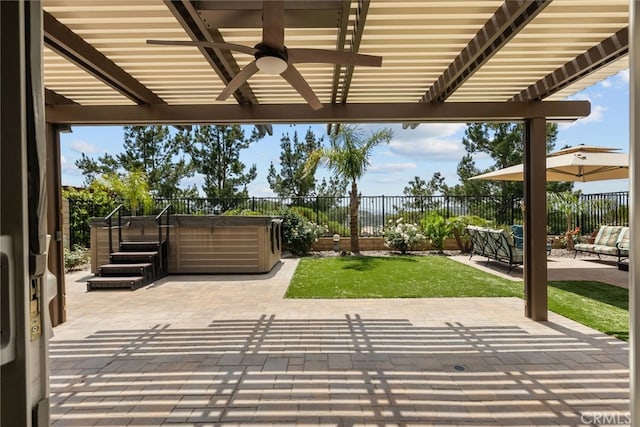 view of patio / terrace with a pergola, ceiling fan, a fenced backyard, and a hot tub