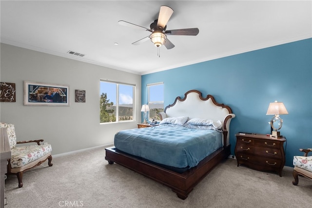 bedroom featuring ceiling fan, visible vents, carpet, baseboards, and ornamental molding