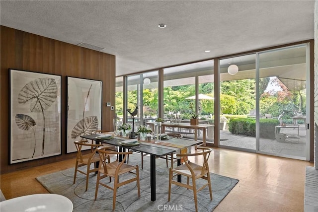 799 Hillview Way, Chico, CA 95926 - dining area featuring floor to ceiling windows, wood walls, and a textured ceiling