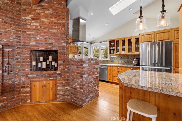 522 High Dr, Laguna Beach, CA 92651 - kitchen with appliances with stainless steel finishes, a skylight, light wood-type flooring, glass insert cabinets, and brown cabinets