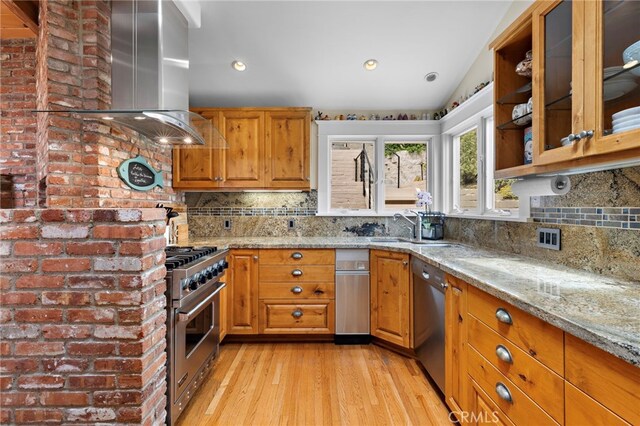 522 High Dr, Laguna Beach, CA 92651 - kitchen featuring appliances with stainless steel finishes, island exhaust hood, light stone counters, light wood-style floors, and lofted ceiling