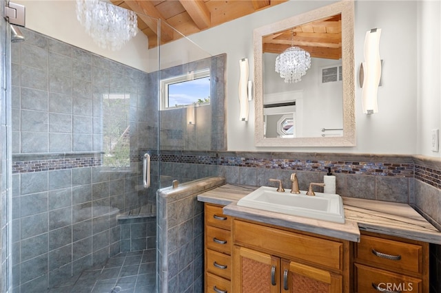 522 High Dr, Laguna Beach, CA 92651 - bathroom featuring a chandelier, beam ceiling, tile walls, wooden ceiling, and a stall shower