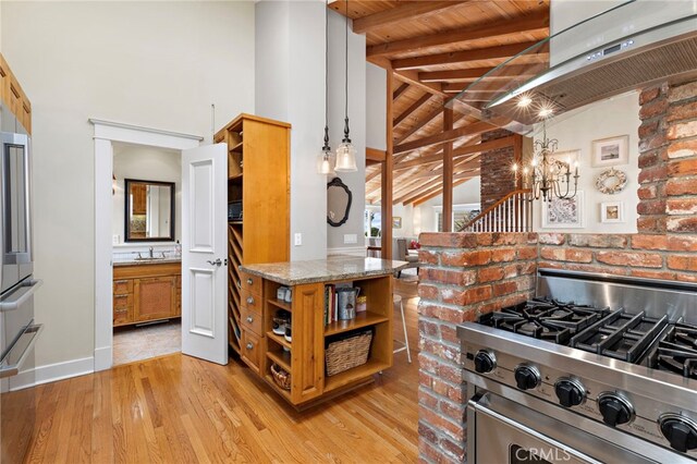 522 High Dr, Laguna Beach, CA 92651 - kitchen featuring open shelves, high end stainless steel range, light stone countertops, a sink, and brown cabinets