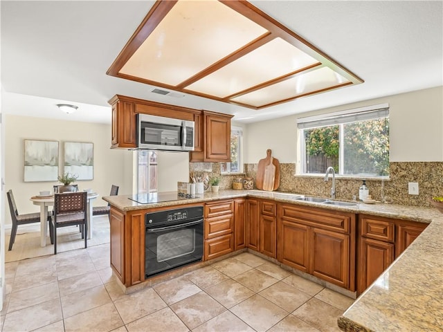 1523 E Pryor Dr, Fresno, CA 93720 - kitchen with a sink, black appliances, brown cabinets, decorative backsplash, and visible vents