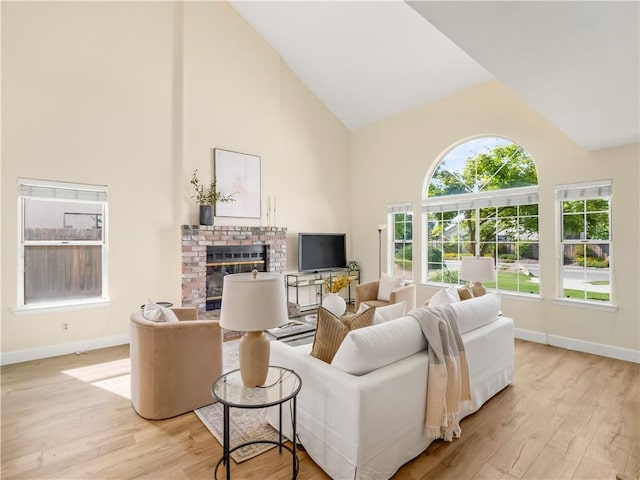 1523 E Pryor Dr, Fresno, CA 93720 - living room featuring high vaulted ceiling, baseboards, light wood-style floors, and a fireplace