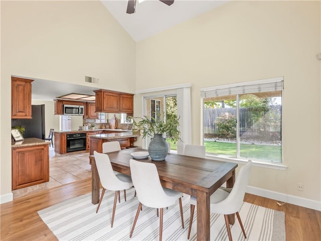 1523 E Pryor Dr, Fresno, CA 93720 - dining area with light wood-type flooring, a ceiling fan, visible vents, and high vaulted ceiling
