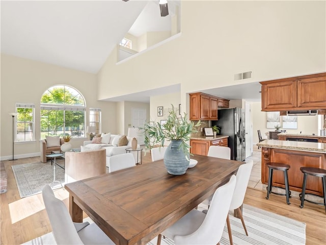 1523 E Pryor Dr, Fresno, CA 93720 - dining space featuring light wood-type flooring, a wealth of natural light, visible vents, and high vaulted ceiling