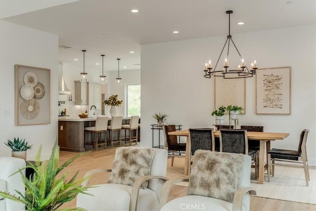 dining area featuring recessed lighting, baseboards, a chandelier, and light wood-style floors