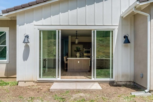 doorway to property with board and batten siding