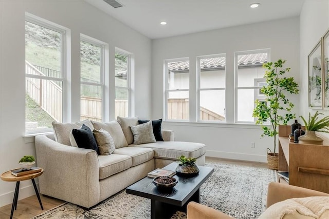 sunroom with visible vents and a healthy amount of sunlight