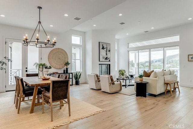 dining room featuring light wood-style floors, a notable chandelier, recessed lighting, and visible vents