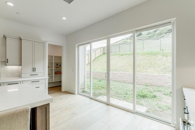 doorway to outside featuring recessed lighting and light wood finished floors
