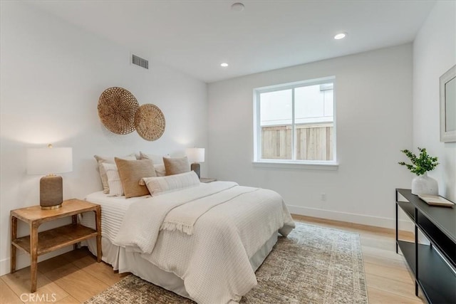 bedroom with visible vents, recessed lighting, light wood-style floors, and baseboards