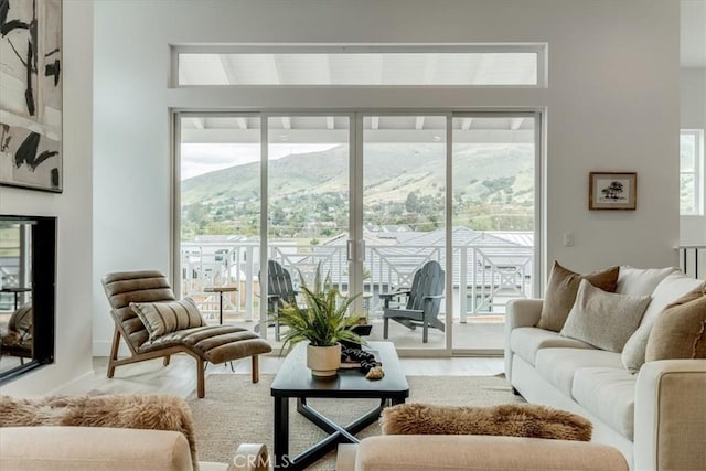 living area featuring a healthy amount of sunlight and a mountain view