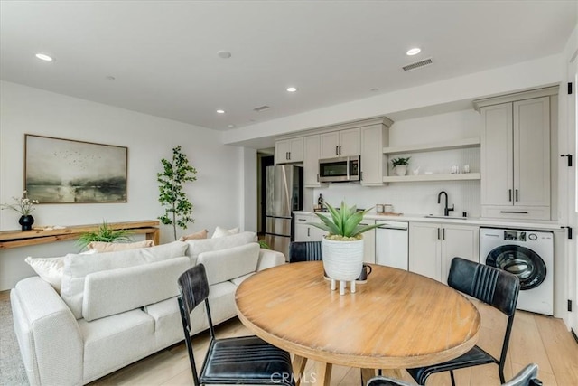 dining room with visible vents, recessed lighting, washer / clothes dryer, and light wood-type flooring