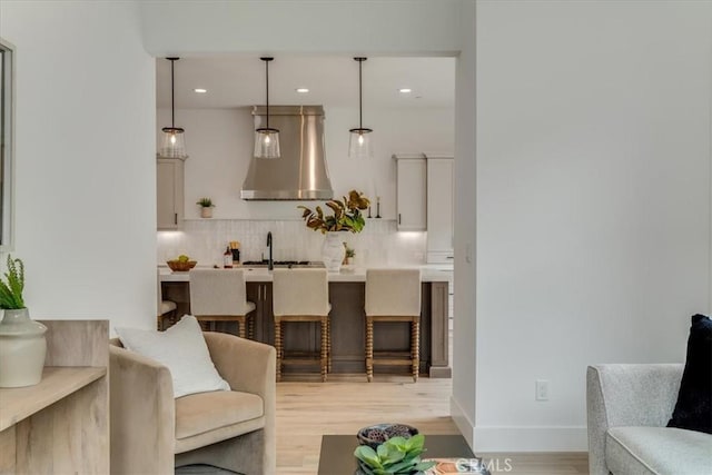 living room with recessed lighting, baseboards, and light wood-style floors
