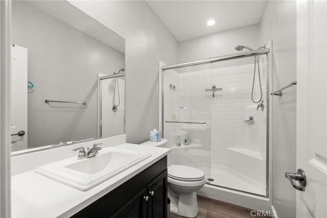 3693 S Grower Ave, Ontario, CA 91761 - full bath with wood finished floors, a stall shower, vanity, toilet, and recessed lighting