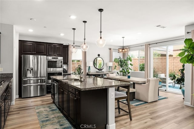 3693 S Grower Ave, Ontario, CA 91761 - kitchen featuring recessed lighting, a kitchen breakfast bar, stainless steel appliances, visible vents, and a sink