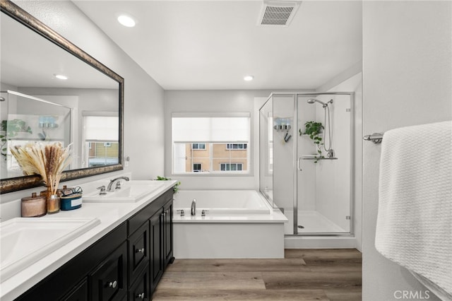 3693 S Grower Ave, Ontario, CA 91761 - full bath with a shower stall, a garden tub, wood finished floors, a sink, and visible vents