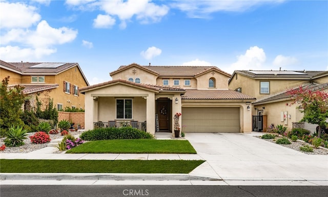3693 S Grower Ave, Ontario, CA 91761 - mediterranean / spanish-style home with concrete driveway, an attached garage, a tile roof, stucco siding, and covered porch