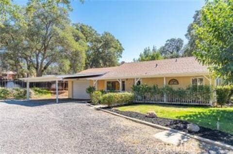 single story home with an attached garage, driveway, and an attached carport