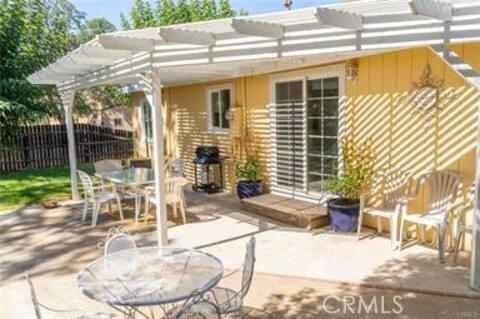 view of patio / terrace with fence, outdoor dining space, and a pergola
